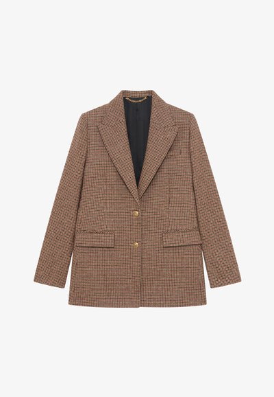 Brązowa marynarka w kratę houndstooth z wyciętym kołnierzem, dwoma przednimi kieszeniami, złotymi guzikami oraz kontrastową czarną podszewką. Dopasowany krój z długimi rękawami.