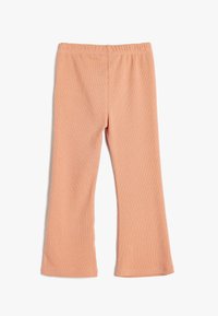 Peachfarvede leggins lavet af ribbet stof, der har en komfortabel elastisk talje og en udvidet kant, designet til let bevægelse.