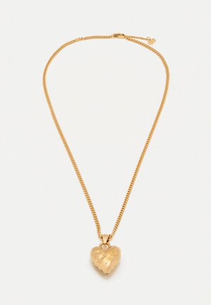 Gold chain necklace featuring a heart-shaped pendant with a polished finish and engraved details, showcasing a smooth texture and curved shape.