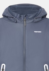 Navy sininen vedenpitävä takki, jossa on vetoketjullinen etuosa, fleece-vuorattu huppu ja valkoiset logoversion korostukset. Kaksi sivutaskua, joissa on metalliset yksityiskohdat.