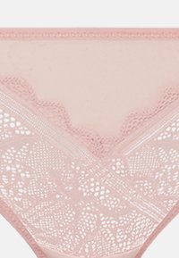 Pink lace thong with floral pattern and scalloped edges. Smooth waistband with diagonal lace panels and semi-sheer fabric.