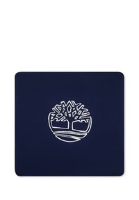 Tapis bleu marine arborant un logo blanc d'un arbre dans un cercle, avec des branches et des racines stylisées. Texture lisse et durable.