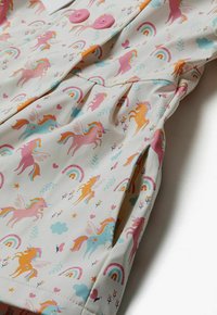 Waterproof coat featuring a pastel-patterned fabric with pink and orange unicorns, rainbows, and clouds, accented by pink buttons and pleats.