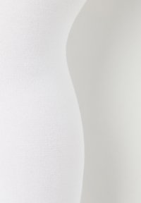 Biała ribbowana tkanina, dopasowany krój o gładkiej teksturze, podkreślająca kontury materiału. Brak widocznych wzorów lub akcentów.