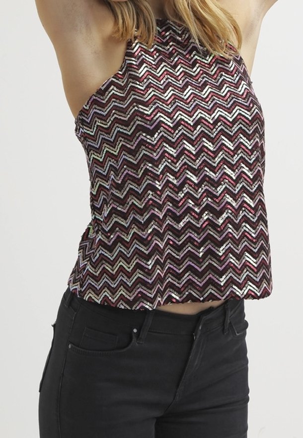 Pailletten tanktop met een zigzagpatroon in bordeauxrood, roze en zilveren tinten. Korte snit tot de taille met een hoge hals en open zijkanten.