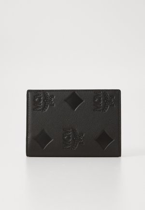 Black leather wallet featuring embossed MCM logo and diamond patterns on the surface, rectangular shape with a smooth texture.