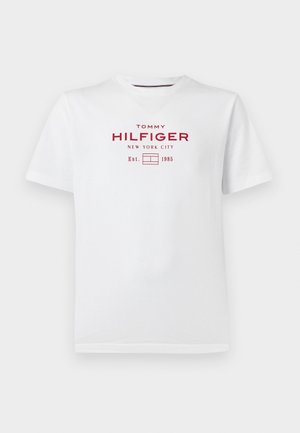 Weißes T-Shirt mit kurzen Ärmeln und Rundhalsausschnitt mit rotem Schriftzug „Tommy Hilfiger New York City Est. 1985“ und Logo mittig auf der Brust.
