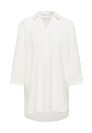 Chemise blanche à manches longues avec un col, patte de boutonnage et ourlet arrondi. Tissu léger avec une texture douce.