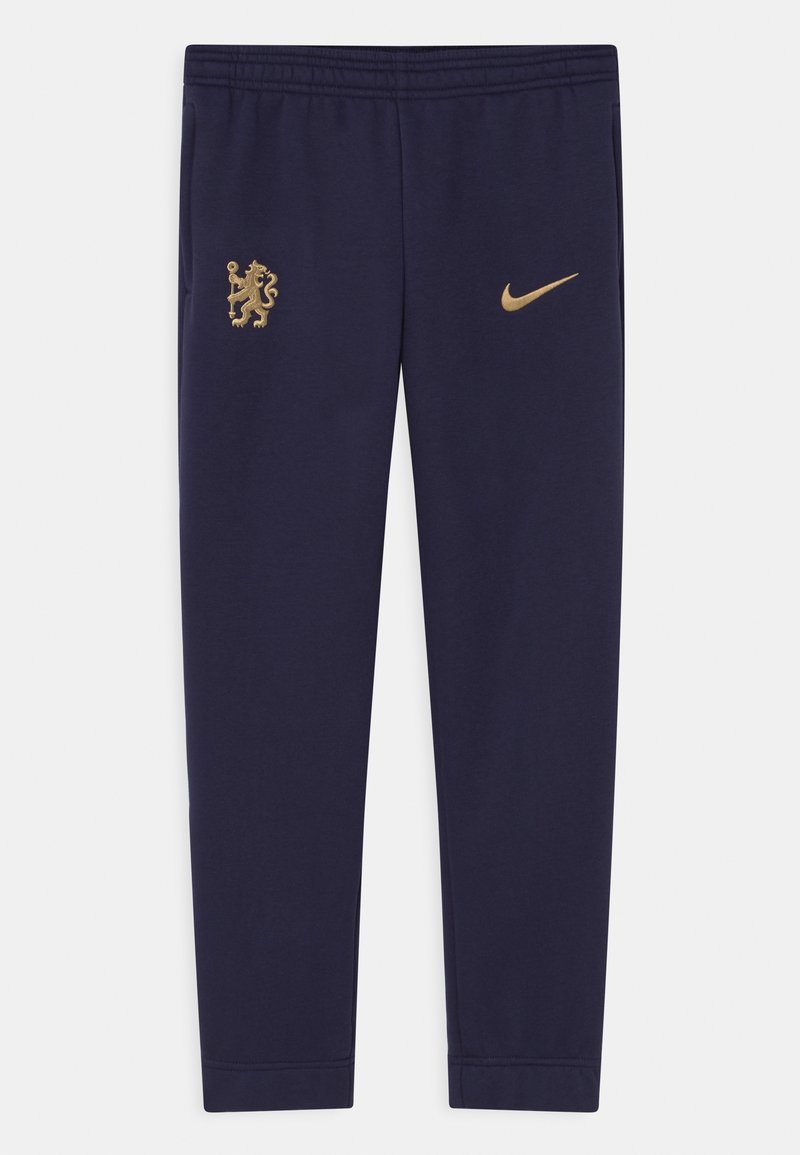 Námořnické sportovní kalhoty vyrobené z jemné látky, s zlatým emblémem lva a zlatým logem Nike swoosh. Elastický pas pro pohodlí.