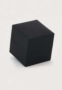 Small black square jewelry box with a hinged lid, closed and placed on a white surface.