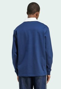 Navy blue long-sleeve polo shirt with a white collar, features ribbed cuffs, classic fit, and smooth cotton fabric.