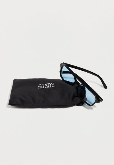 Black sunglasses with rectangular blue lenses resting on a black pouch with white numeric design and a circled number six.