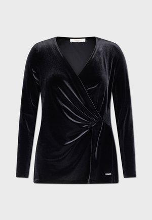 Black velvet top with long sleeves, V-neckline, and gathered twist detail at the waist. Features a subtle logo accent at the hem.