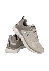 Zapatillas deportivas beige con parte superior de malla, acentos grises y suelas blancas. Presenta un collar acolchado y una pestaña en el talón a rayas para un detalle adicional.