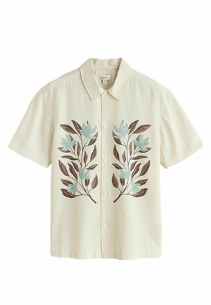 Beiges Kurzarmhemd mit Knopfleiste und blauer Blumen- sowie brauner Blätterstickerei auf der Vorderseite. Weicher, strukturierter Stoff.