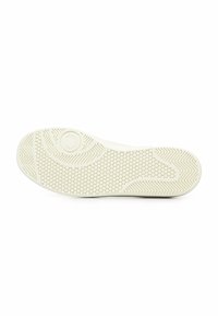 Suola di una sneaker, con un motivo a nido d'ape testurizzato di colore crema chiaro, dettagli a spina di pesce e marchio.