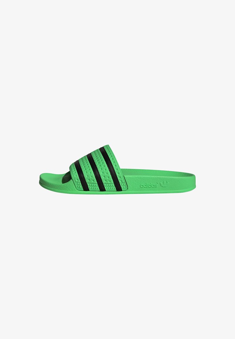 Green slide sandal with three black stripes on the upper band, made of textured rubber, featuring a flat sole and branded logo.