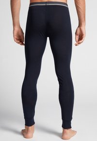 Marine thermoleggings met een slimfit ontwerp, een elastische tailleband met een grijze streep en ribgebreide manchetten bij de enkel. Zachte stof.