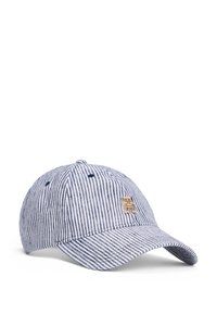 Striped baseball cap made of cotton in blue and white colors. Features a curved brim and a gold emblem on the front.