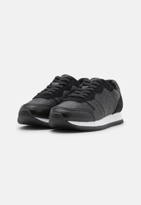 Black athletic shoes with a mix of smooth and textured materials, featuring a repeated logo pattern, lace-up design, and white midsole.