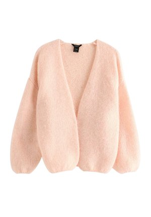 Pehmeä vaaleanpunainen neulottu neuletakki, jossa on ylisuuria hihoja, avoin etuosa ja hieman väljä istuvuus.