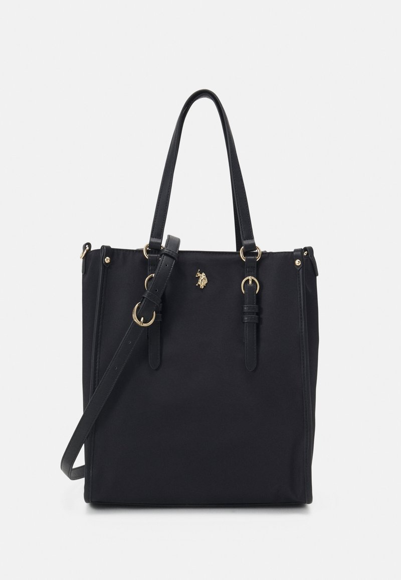 Sac cabas noir avec deux bretelles, bandoulière ajustable et emblème doré cavalier sur le devant.