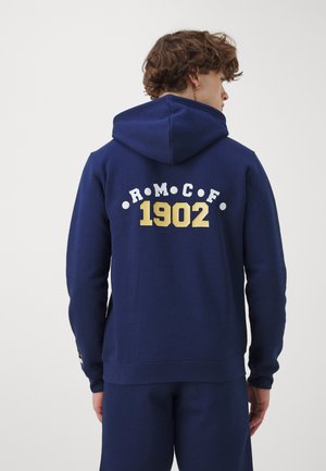 Navy blue hoodie with a round hood. Features white and gold printed text "R.M.C.F." and "1902" on the back. Soft, textured fabric.