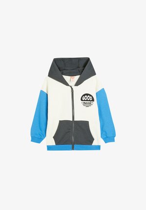 Hættejakke med lynlås i creme, grå og blå. Har forlommer, "GOOD" tekstdesign, ribbede manchetter og en blød stoftekstur.