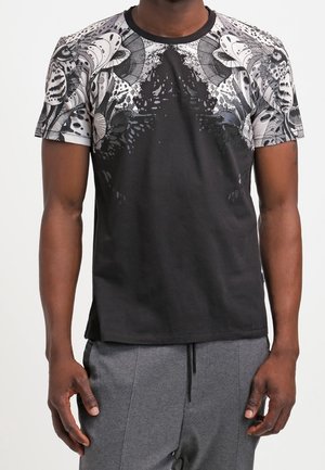 Schwarzes T-Shirt mit einem gemusterten Design in Grautönen und Weiß an den Schultern, Rundhalsausschnitt und kurzen Ärmeln.