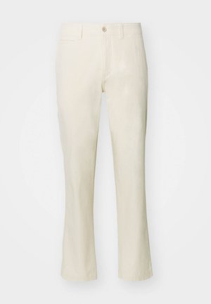 Beige Baumwollhose mit geradem Bein, ausgestattet mit einem Knopfverschluss und einer Seitentasche. Glatte Textur und schlichtes Design.