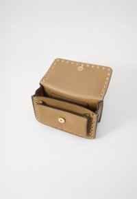 Portefeuille en cuir tan avec des clous dorés le long des bords, doté d'une fermeture à rabat et d'une poche intérieure pour cartes ou espèces.