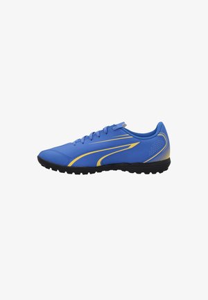 Scarpa sportiva blu con accenti gialli, tomaia sintetica, punta rotonda e suola in gomma nera con modelli testurizzati per la presa.