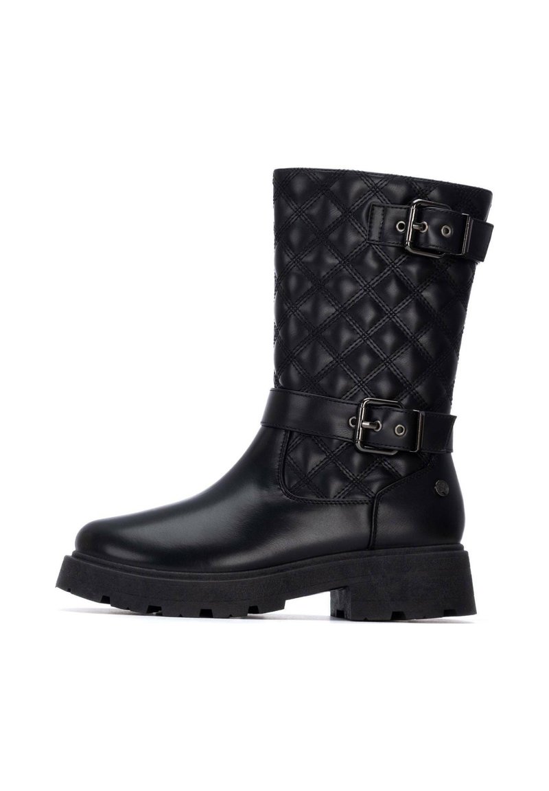 Bota negra hasta la rodilla con un patrón acolchado, material de cuero, dos hebillas ajustables y una suela de goma gruesa. Superficie lisa y acabado mate.