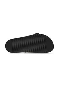 Sole di sandalo in gomma nera con righe orizzontali per la trazione, caratterizzata da un lato inferiore liscio e un design minimale.