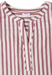 White shirt with vertical red stripes, round neckline with a front slit, and a visible brand label "CECIL" inside the collar.