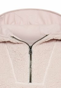 Roze fleece hoodie met een ritssluiting aan de voorkant. Kenmerkt zich door een zachte textuur, een capuchon en contrasterende ritsdetails.