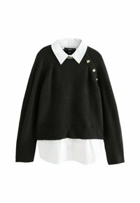 Sort strikket sweater med hvid krave, cropped længde, ribbet kant og tre guldknap detaljer på venstre skulder.