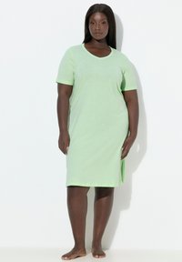 Light green short-sleeve dress with a V-neck, made of soft fabric, featuring a subtle pattern and contrasting trim along the neckline and sleeves.