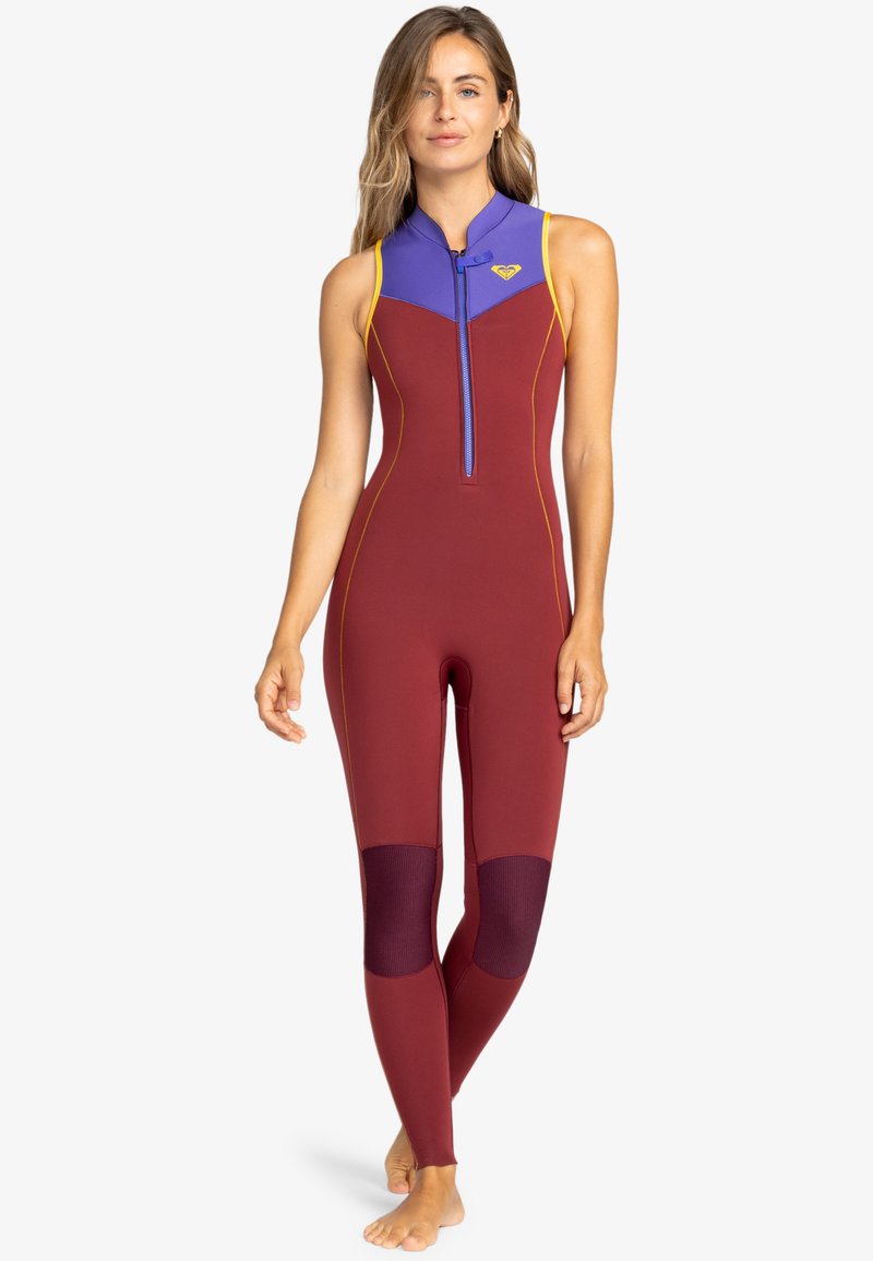 Red and purple wetsuit with a high collar, front zip closure, and contrasting yellow stitching. Features mesh panels on knees for breathability.