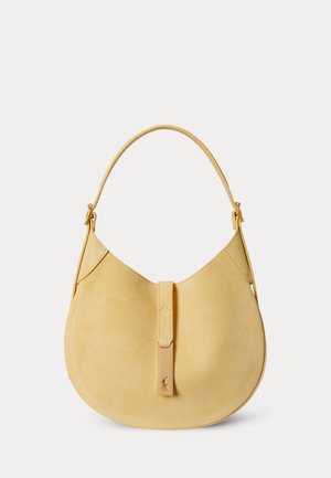 Beige suede crescent-shaped handbag with a single strap and a front tab featuring a small embossed logo.