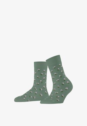 Chaussettes basses vertes avec de petits motifs floraux violets et blancs répartis uniformément sur les deux chaussettes.
