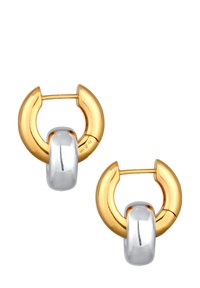 Boucles d'oreilles en or et en argent présentant un design circulaire avec un large accent argenté arrondi au centre. Fini poli.