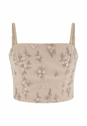 Camisole beige courte avec fines bretelles, présentant de délicats motifs floraux brodés en tons doux de rose et marron.