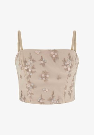 Camisole beige corta con sottili spalline, decorata con delicati motivi floreali ricamati in tonalità rosa tenue e marrone.