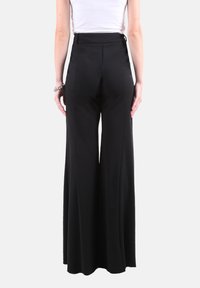 Pantaloni neri a gamba larga con vita alta, realizzati in tessuto liscio e design pulito e sartoriale. Senza tasche o decorazioni visibili.