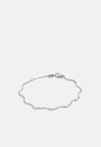 Silver bracelet featuring wavy links, smooth texture, and a lobster clasp closure, with a chain extension for adjustable fit.
