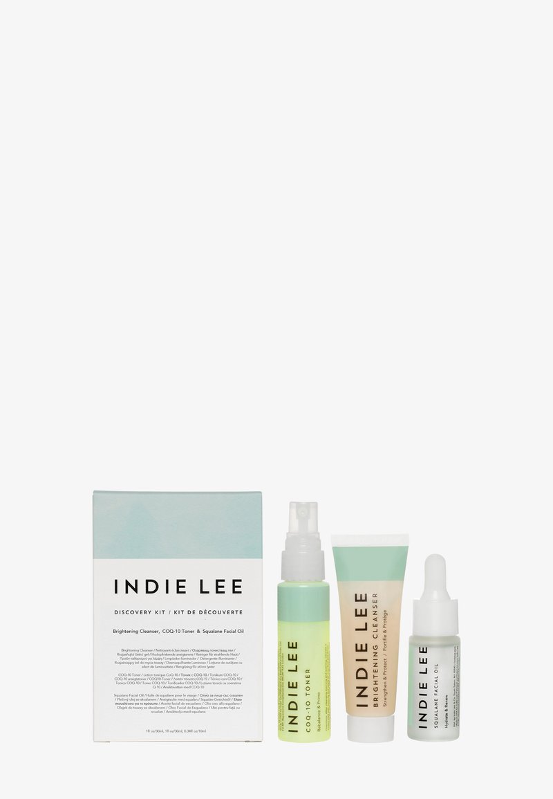 Indie Lee Discovery Kit, jossa on kolme pulloa: vihreä toner, valkoinen puhdistusaine ja kirkastava kasvoöljy, pastellivärisessä laatikossa, jossa on minimalistinen muotoilu.