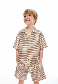 Randig kortärmad skjorta och shorts-set i beige och bruna nyanser, med knappar och sidofickor, tillverkat av mjukt tyg.