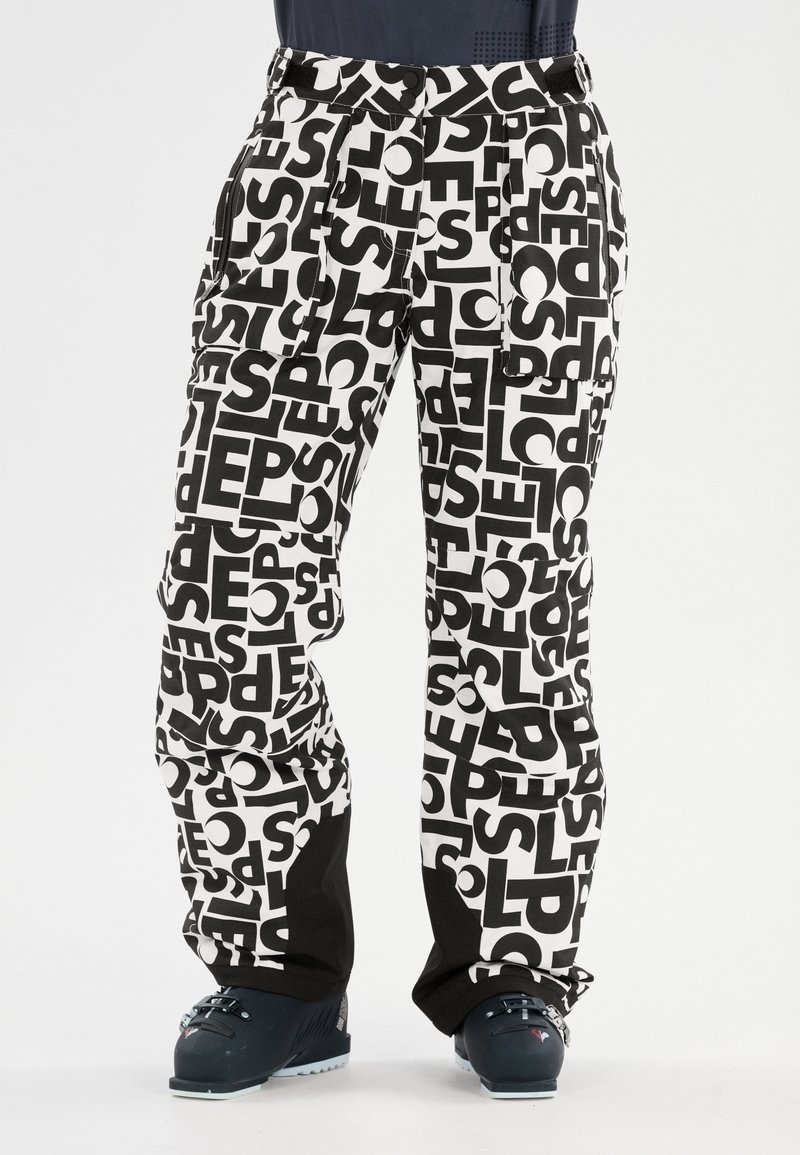 Zwart-witte gestreepte sneeuwbroek met grote blokletters; voorzien van zijzakken en een slim-fit ontwerp met licht uitlopende onderkanten.