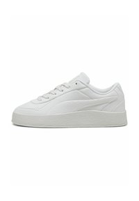 White sneaker with a smooth leather upper, textured accents, and a thick rubber sole. Features classic lacing and a rounded toe design.